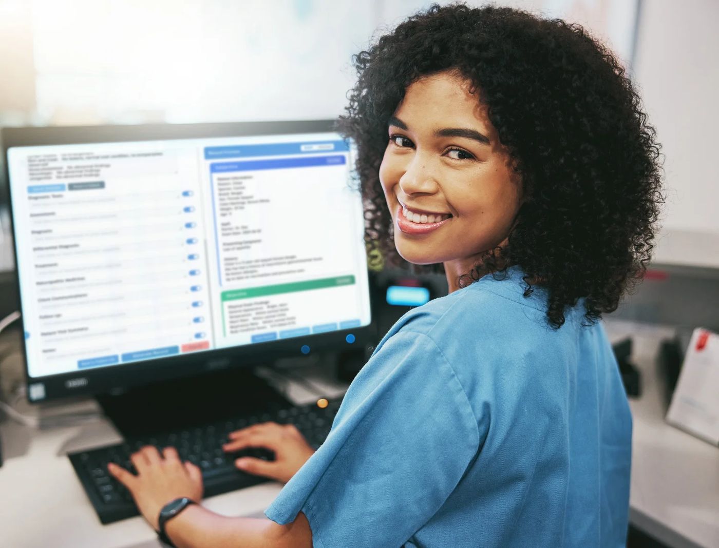 A smiling veterinarian with a finished SOAP note on her computer